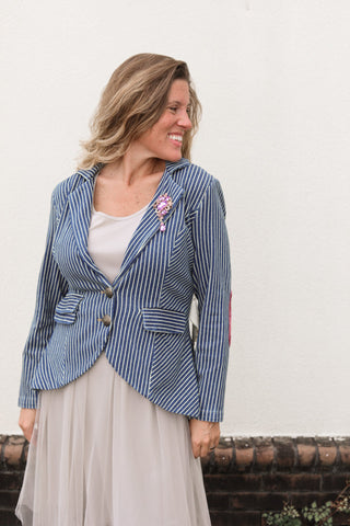 Model wearing the striped Alaia denim blazer